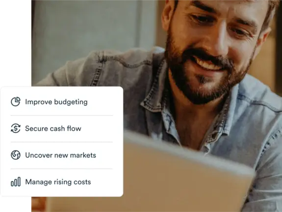 Young man using his tablet while sitting with graph