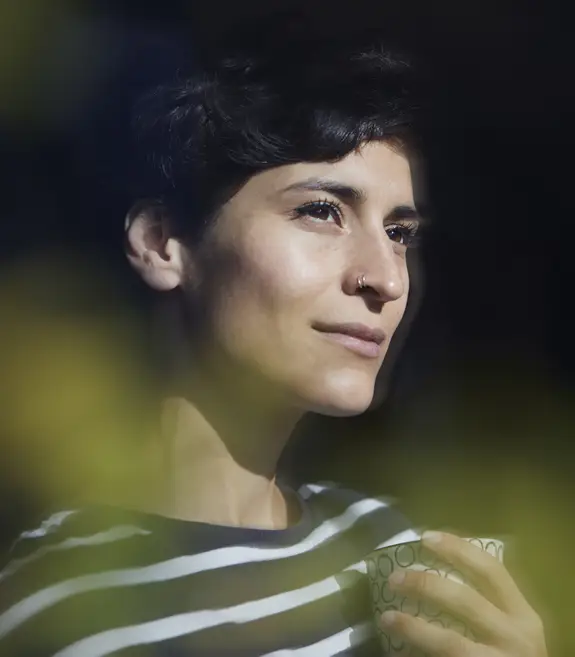 a dreamy woman looking through a window